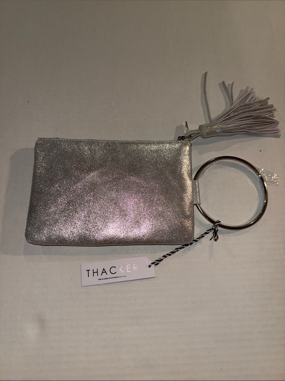 Thacker Silver Metallic Wristlet Clutch with Bangle Handle and Tassel